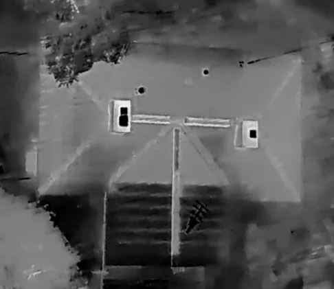 Thermal imagery of a building roof showing heat-loss patterns